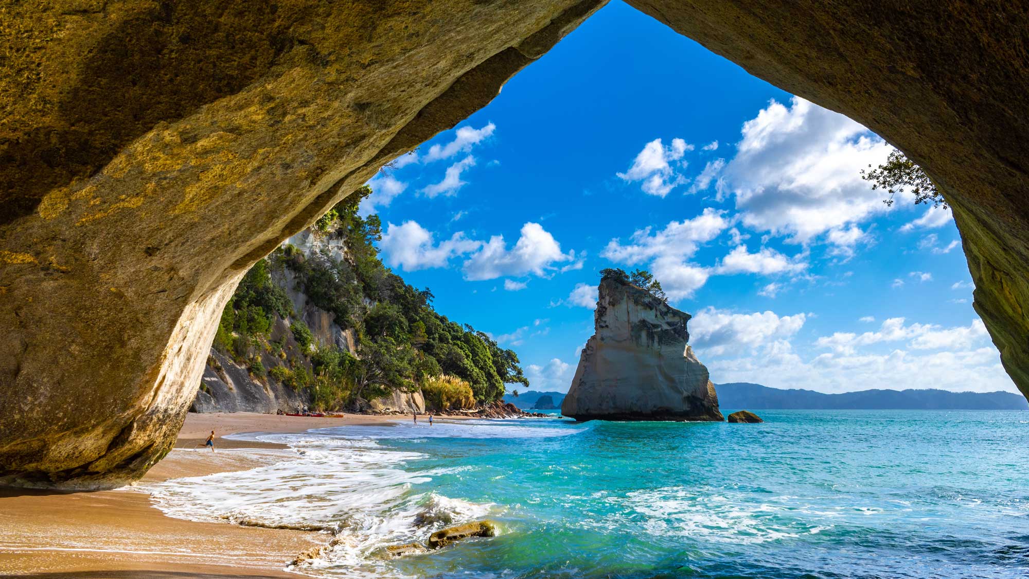 Landscape View through rock arch towards Te Hoho Rock at Cathedral Cove, Coromandel Peninsula - New Zealand