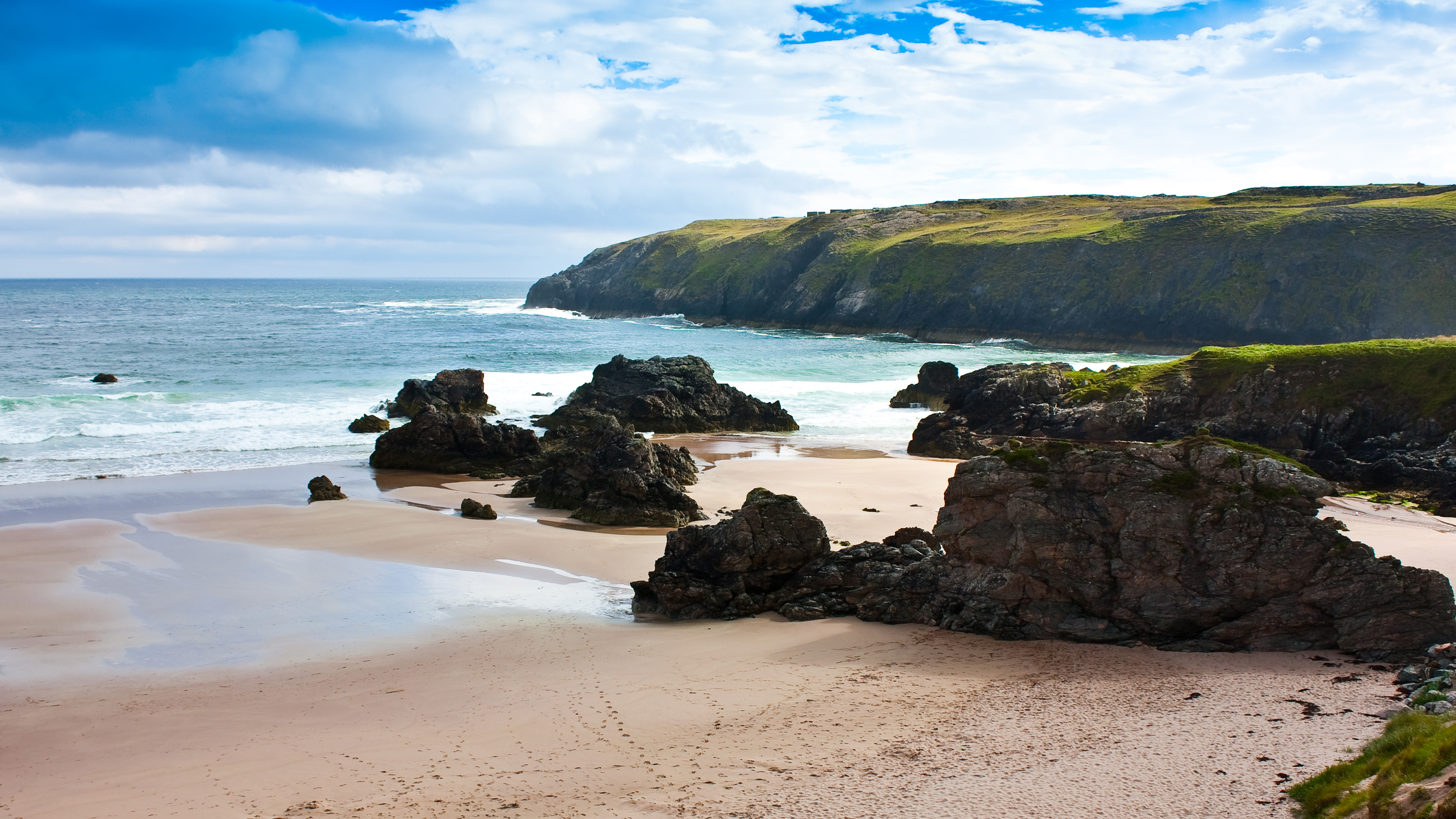 sandy Durness Beach surrounded by rocks in Scotland