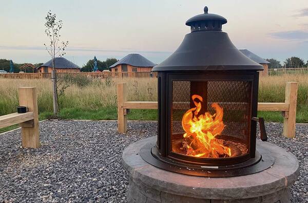 Fire pit and woodern yurts at Experience Freedom