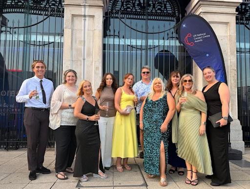 Contact Centre award winners in a group photo all dressed up and smiling.