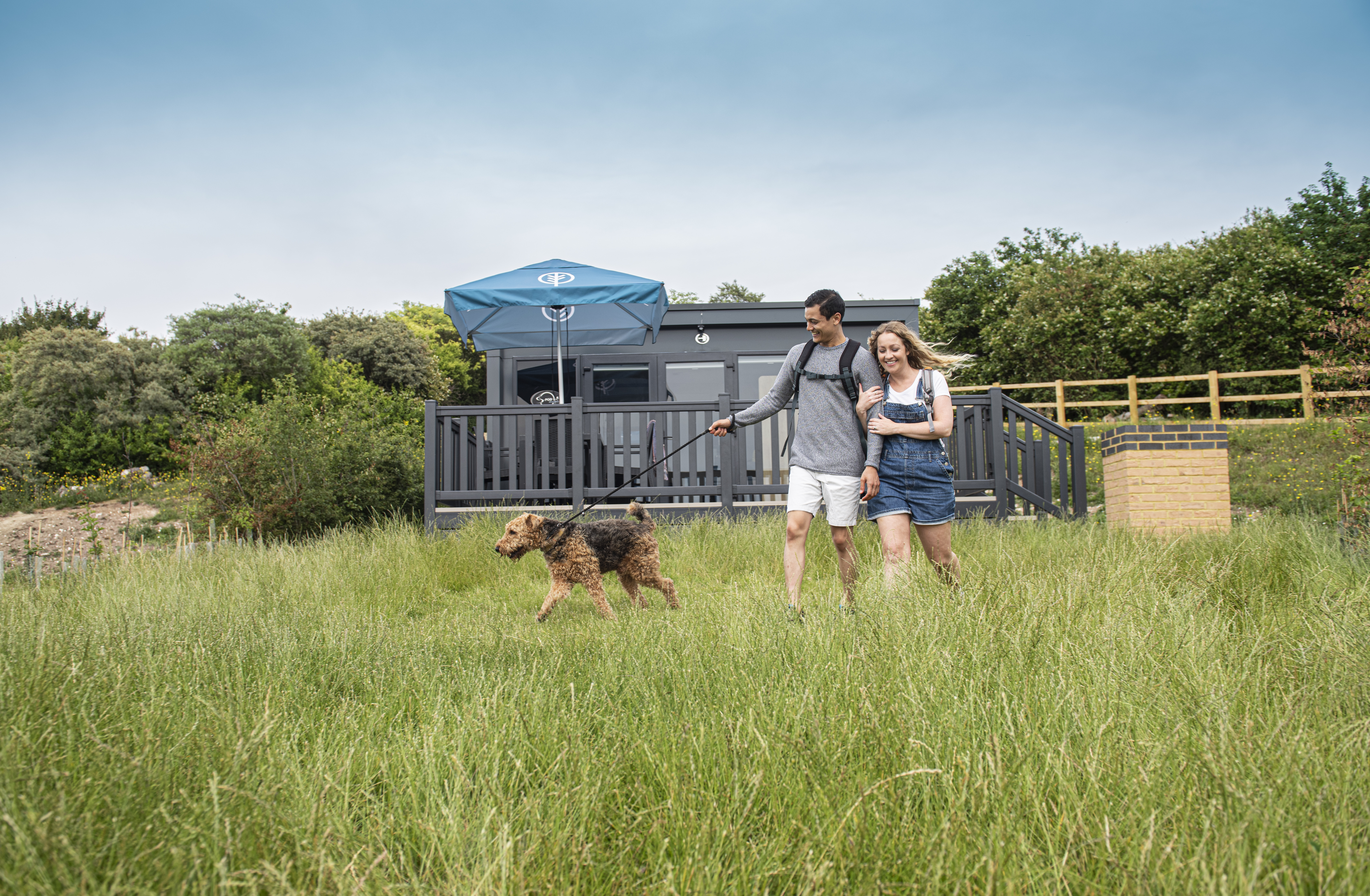 Couple with dog glamping pod