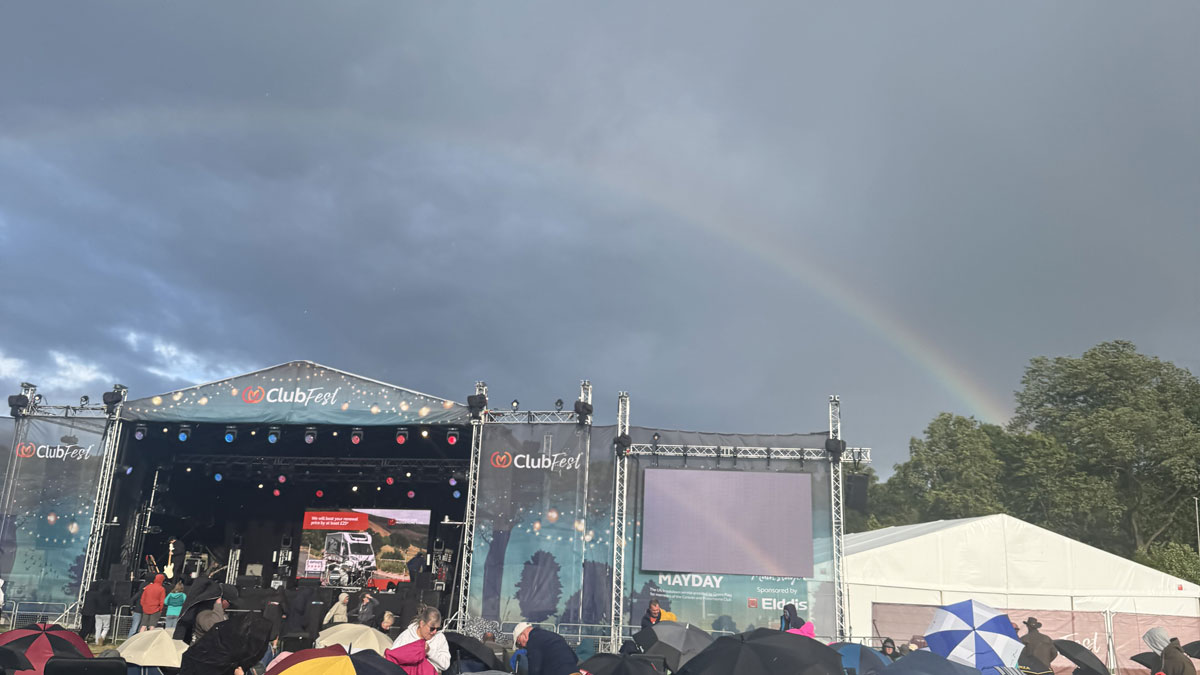 a rainbow arcs over the ClubFest stage