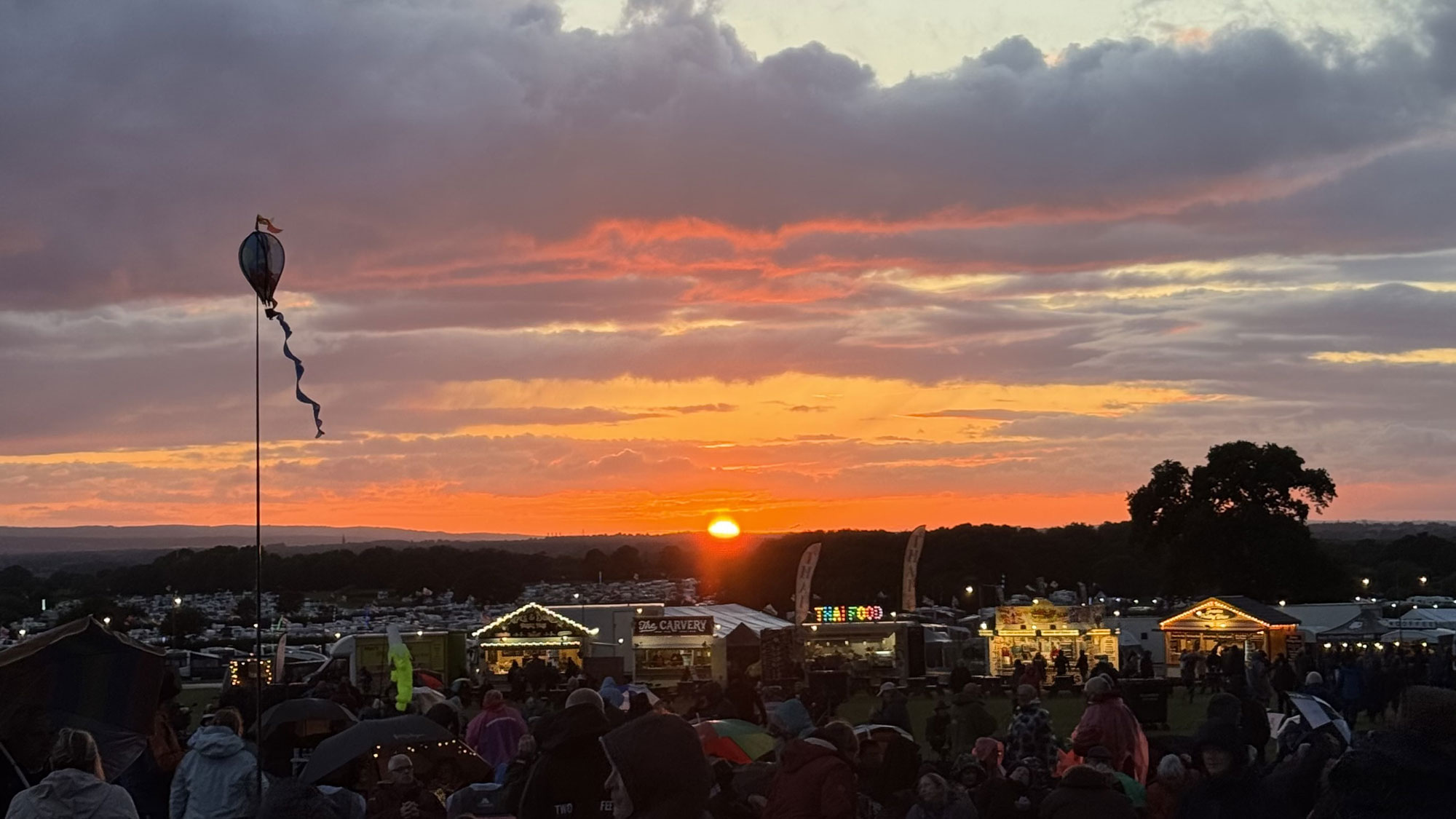 The sun just dips below the horizon behind ClubFest