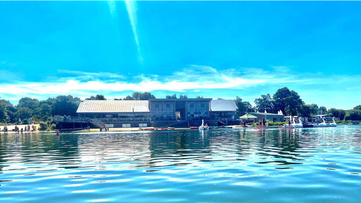 calm water on the lake looking back at the beach where boats await