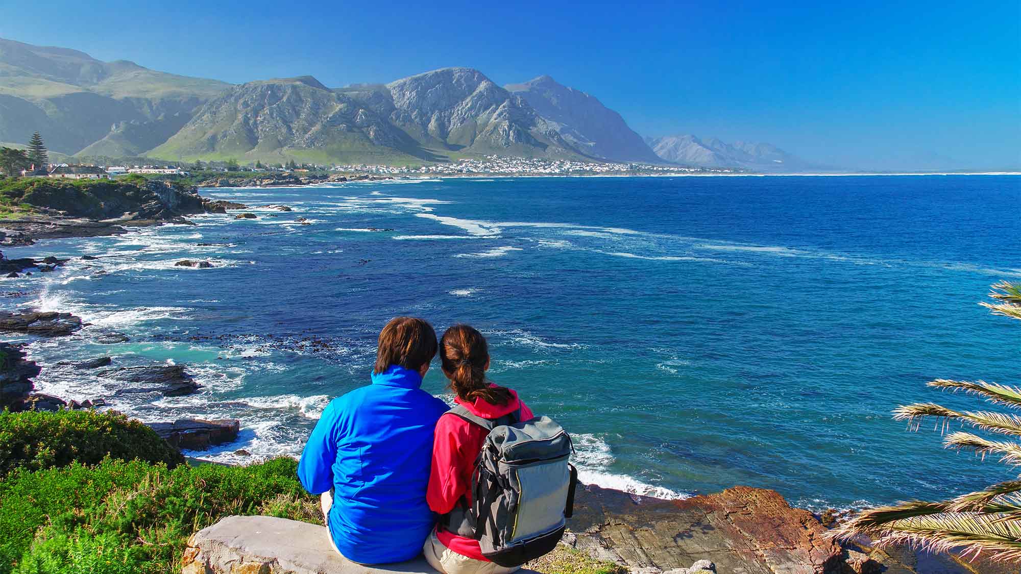 A couple looking out onto the beautiful ocean view in Hermanus South Africa