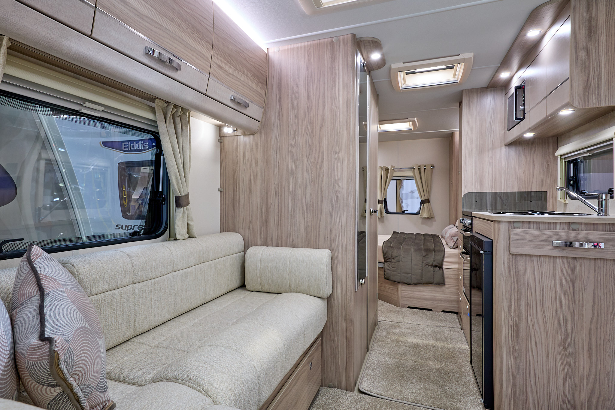 Elddis Avante 454's interior has pale wood furniture and its upholstery is cream.  The bedroom is to the rear and it has a large skylight.