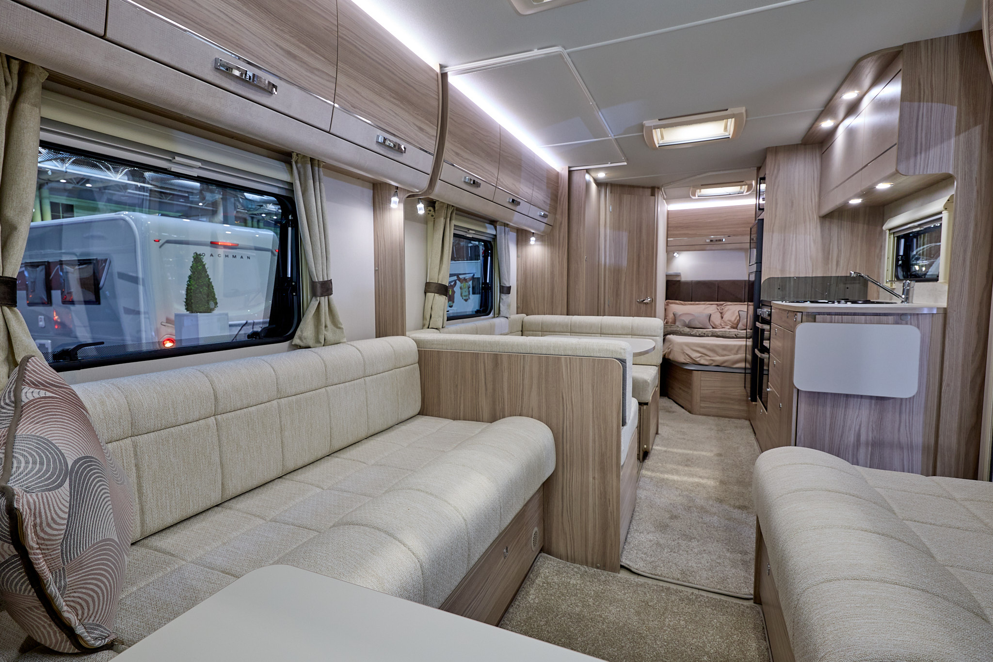 Elddis Avante 840's interior has pale wood furniture and its upholstery is cream.  The bedroom is to the rear and it has a large skylight.