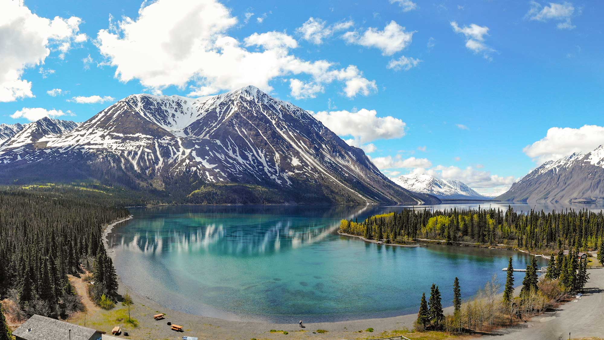 Greeny-blue Kathleen Lake, Canada, seen against the mountains beneath a deep blue sky