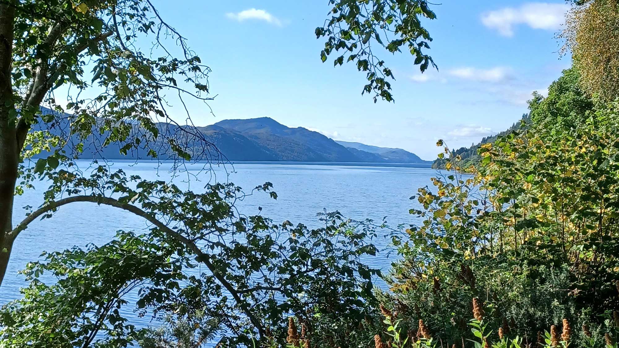 Distant blue hills, across the blue waters of Loch Ness, seen from the water's edge