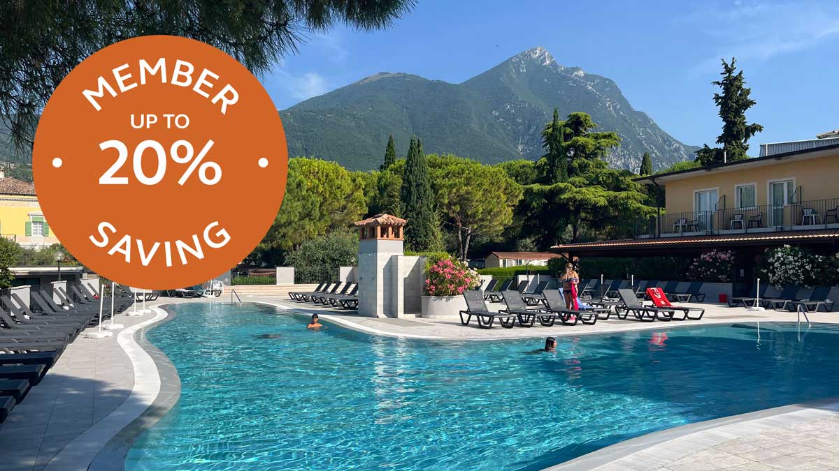 swimming pool, deck chairs, people, mountain, trees