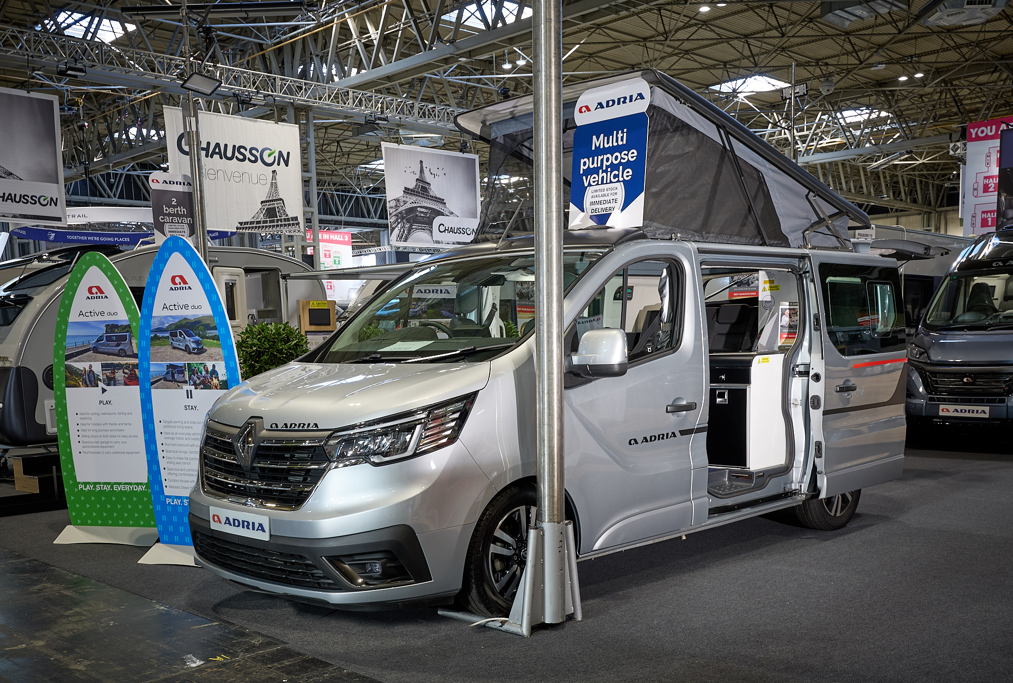 Adria Active Duo's exterior is silver, the sliding door is open and the roof is extended.