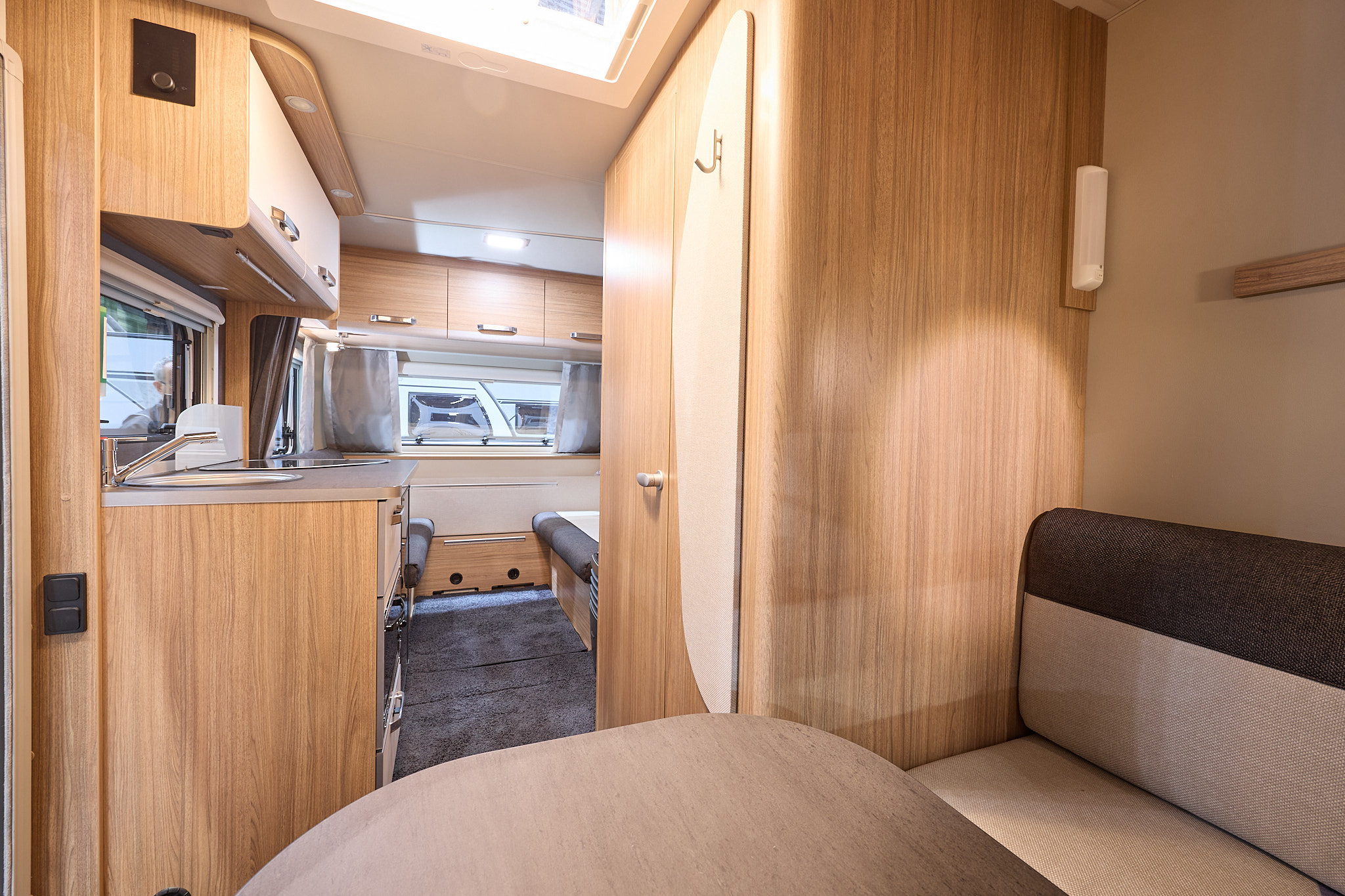 Weinsberg CaraOne 400 LK Dinette's interior is primarily wooded, the dinette is situated in the front with two tone brown seating.  The two single beds are situated at the rear.