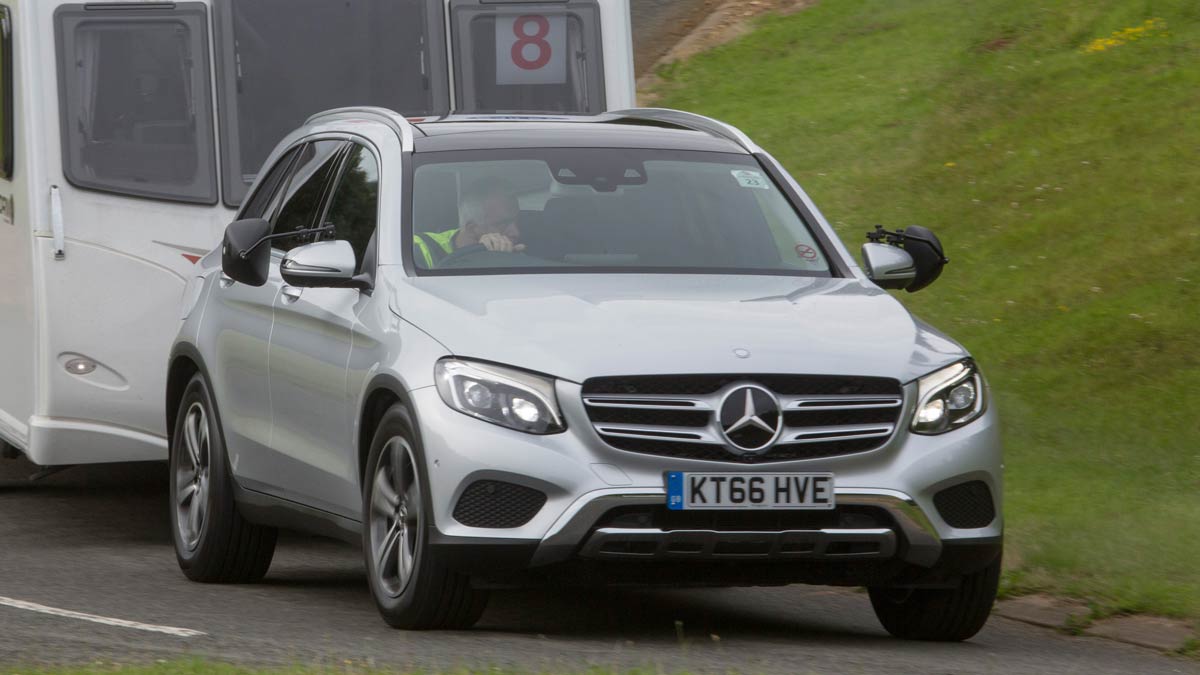 Silver Mercedes towing a white caravan