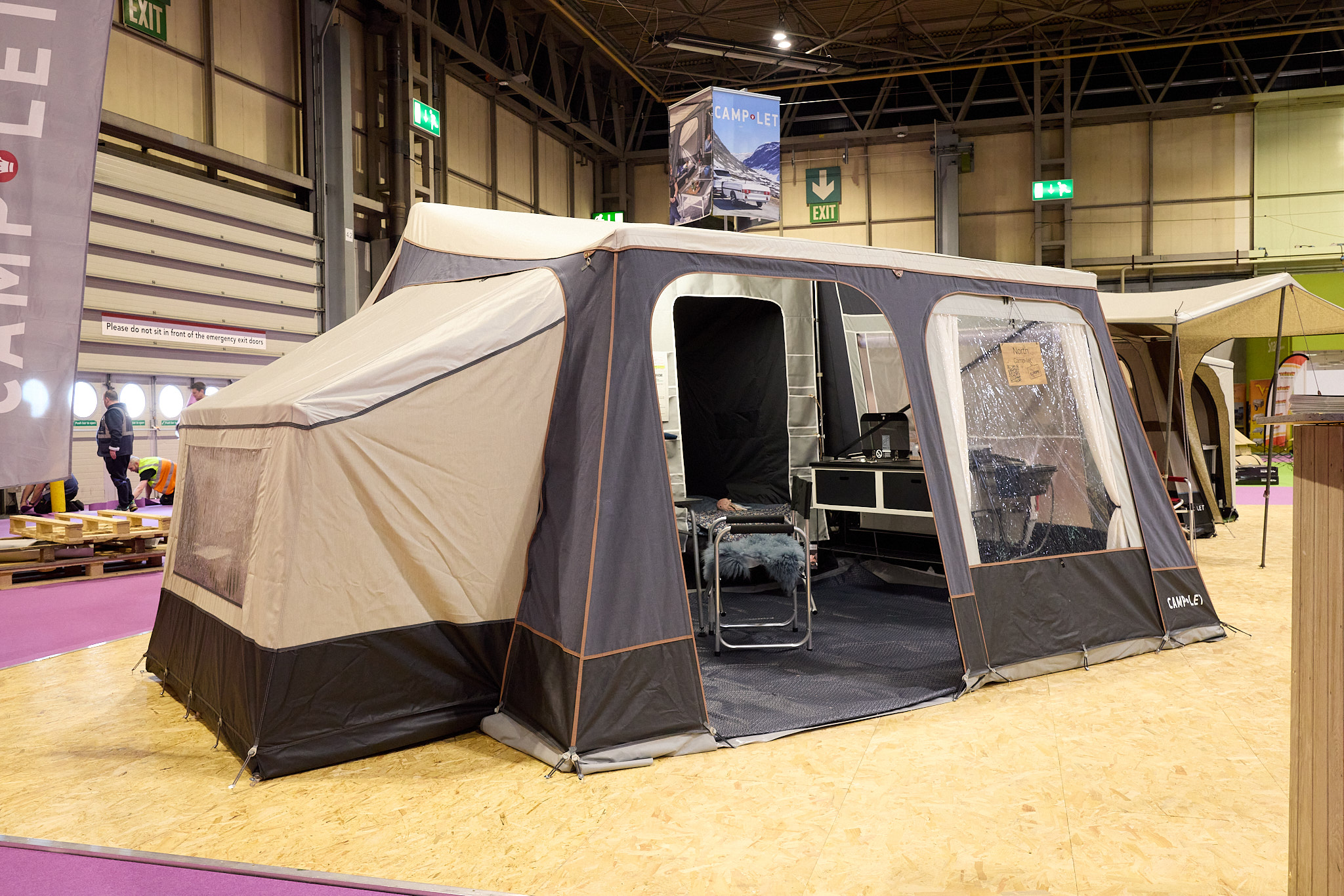 The Camp-Let North has a cream canvas roof with a grey canvas for the main body of the tent.  The doors are open revealing the interior.