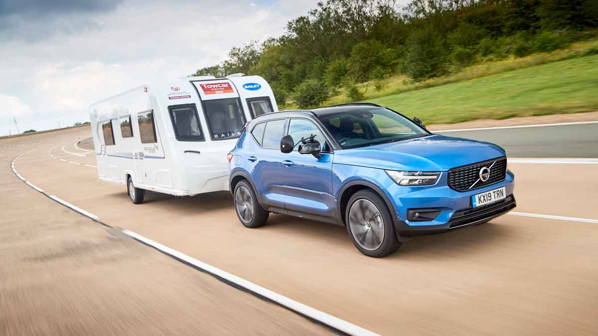 Blue volvo towing a caravan 
