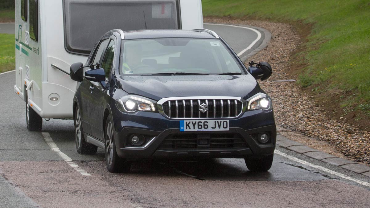 Black Suzuki towing a caravan
