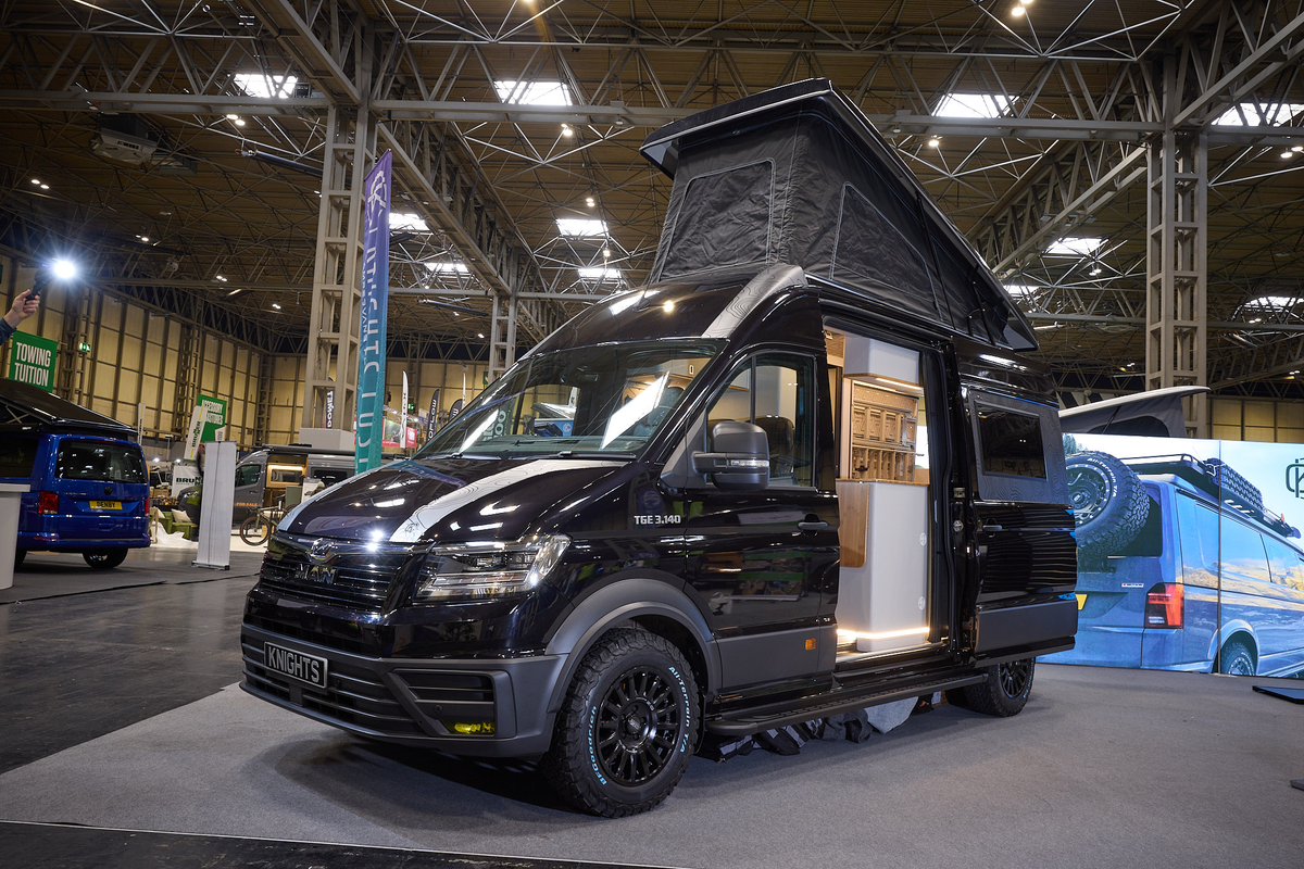 The Knights Custom Conversion Prestige XL is black.  The sliding door is open and its rising roof is fully extended.