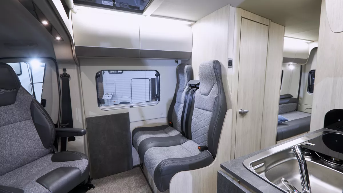 Interior, light wood cupboards, grey upholstery, kitchen sink