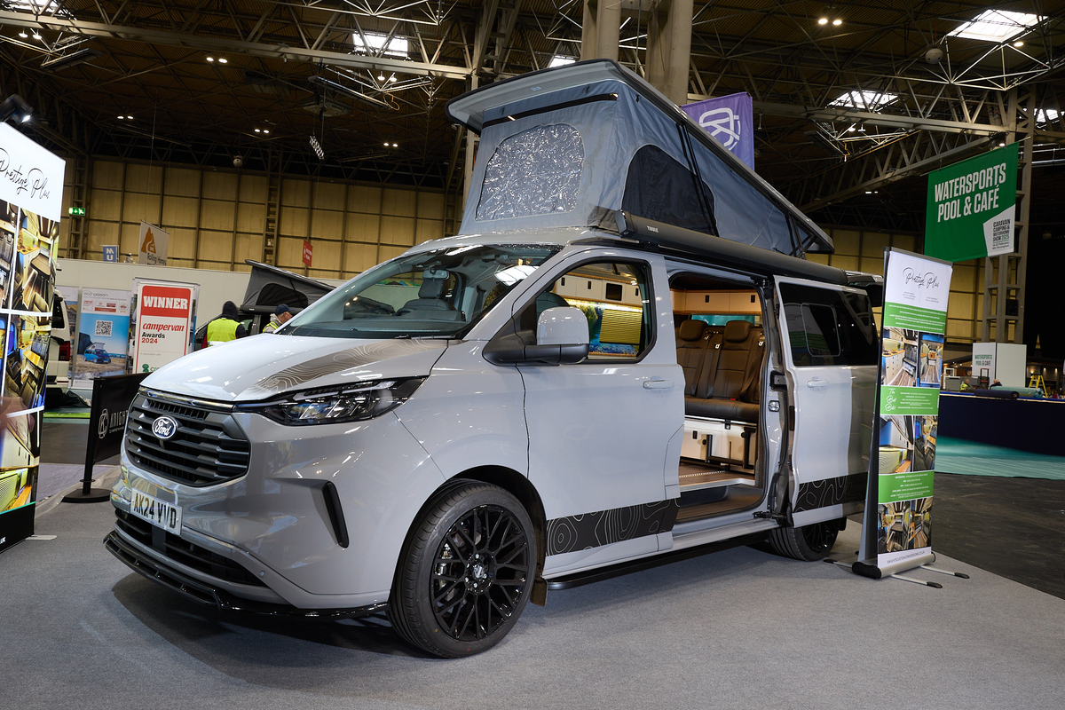 The Knights Custom Conversion Prestige Tourer Plus is grey.  The sliding door is open and its rising roof is fully extended.