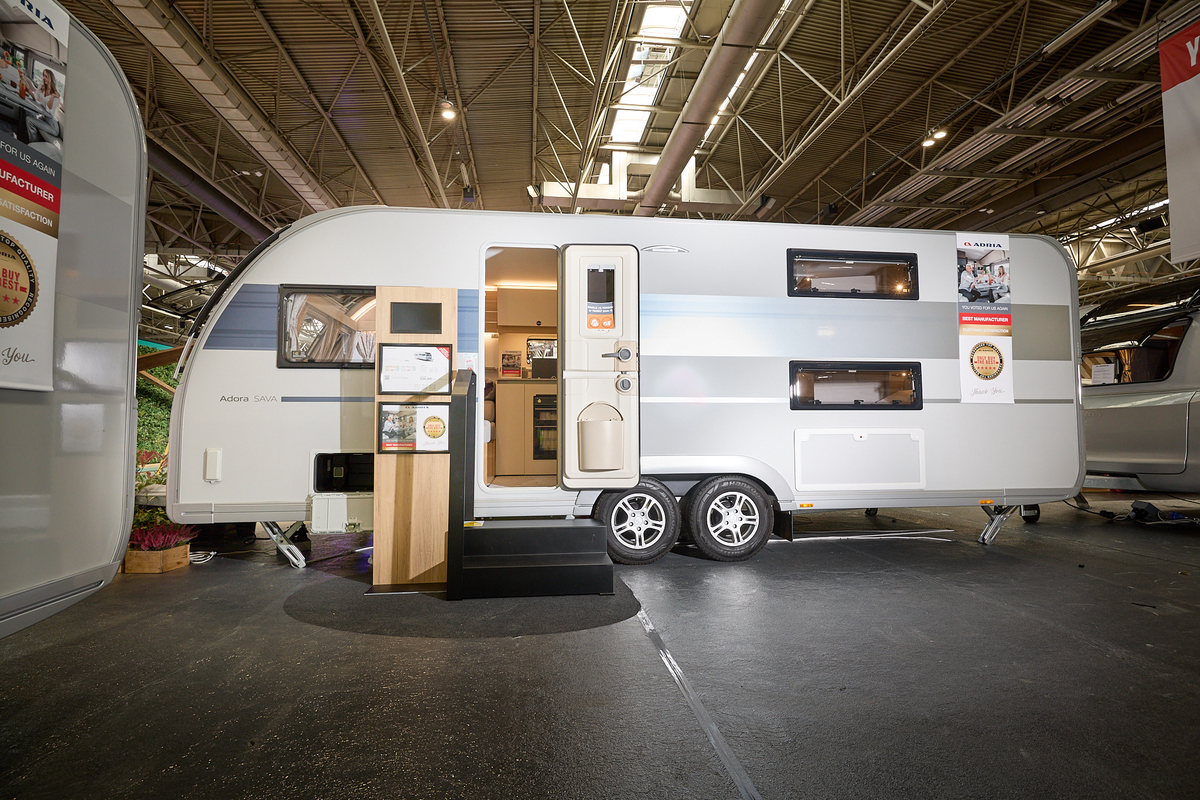 Adria Adora 623 DT exterior, twin axle, white, blue horizontal stripe, windows either side