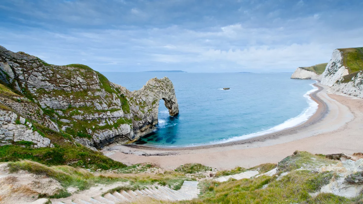 Blue sea and a sandy cove at Durdle Door in Dorset