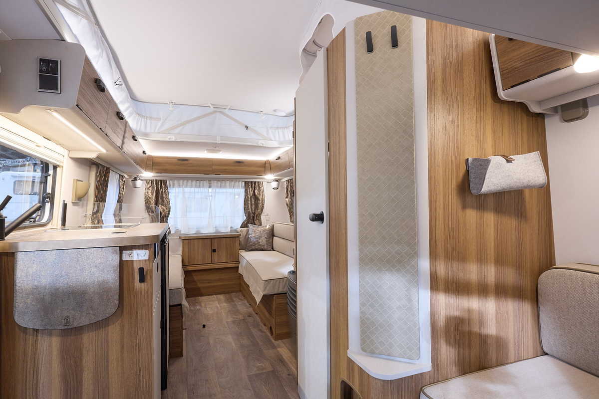 Eriba Touring 540 interior, beige/wood interior, rear lounge, kitchen, front lounge, pop top roof.