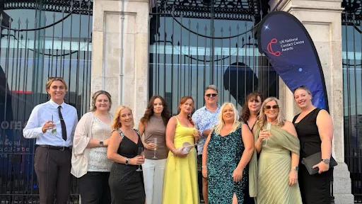 Contact Centre award winners in a group photo all dressed up and smiling.