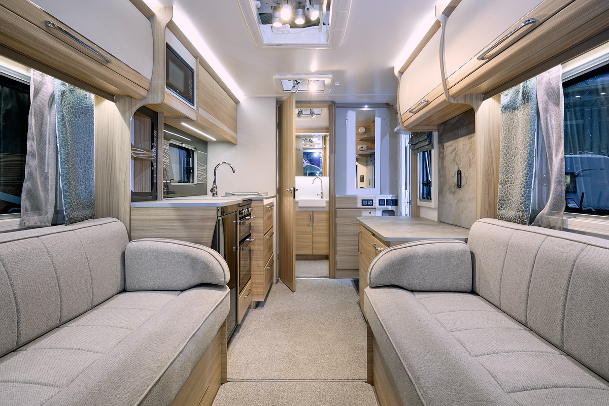 Bailey Unicorn Seville interior, grey upholstery, cream/wood overhead lockers, light wood furniture, lounge, kitchen, washroom, three skylights